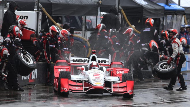 Team Penske’s Helio Castroneves leaves the pit area during Sunday’s race. He collided with teammate Will Power on the 64th lap and finished 19th.