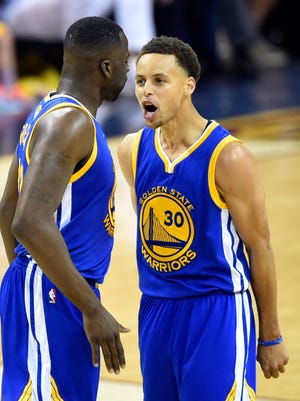 Warriors guard Stephen Curry celebrates with forward Draymond Green during the third quarter of Game 6.
