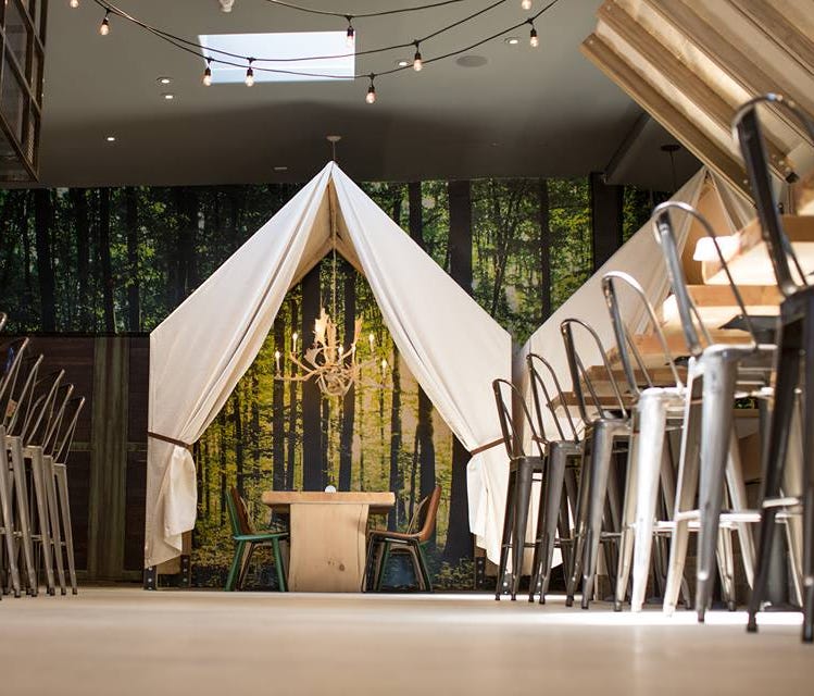 The nature and safari-themed restaurant nods to glamping with this tent.