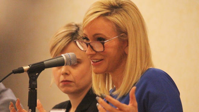 Paula White speaks at a panel for the Religion News Association conference in Nashville on Saturday morning