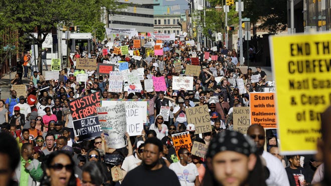 Protesters march through Baltimore on May 2, the day after charges were announced against police officers in the death of Freddie Gray. According to a poll, 44 percent of respondents rated as extremely or very important the deaths of blacks in encounters with police that sparked protests in Baltimore, Chicago and elsewhere.