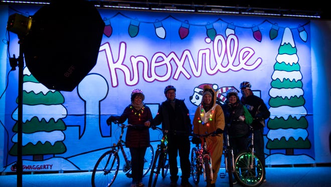 Festive friends gather for a photo before Knoxville's Tour de Lights bike ride in Market Square Friday, Dec. 15, 2017.