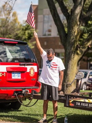 Dan Madrigal show his respect as the national anthem played during the 911 Remembrance ceremony at McCamlyPark on Sunday.