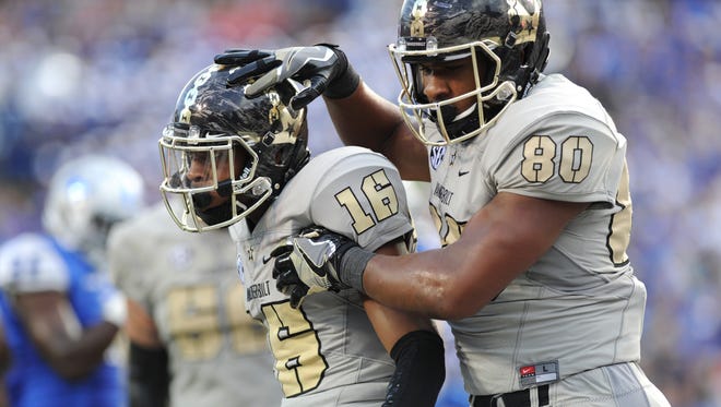 Vanderbilt tight end Jared Pinkney (80) celebrates with wide receiver Kalija Lipscomb (16) after Lipscomb's touchdown catch late in the second quarter against MTSU last season.