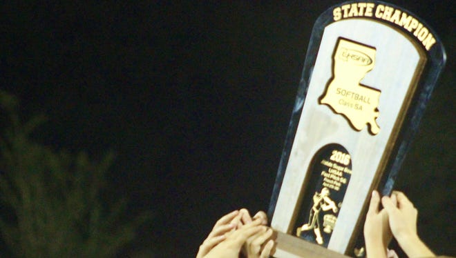 The ASH Lady Trojans hoist the Class 5A Softball State Championship Trophy last May. ASH is the No. 1 seed in Class 5A and is poised to return to Sulphur for the fourth straight year.