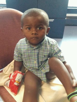 A woman found this 2-year-old boy wandering alone in a parking lot near Dover Monday morning.