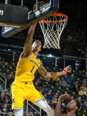 Michigan's Charles Matthews dunks in the first half against North Florida on Saturday night.