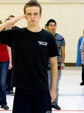 West High School Junior Navy ROTC Ensign Sam Hassett salutes during drills on Wednesday, October 12, 2011. West's Navy Junior ROTC program is ending after being on probation last year for having fewer than the required 100 cadets. The numbers have since risen, but the Navy decided to still end the program. 