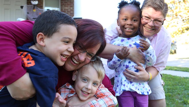Nolan, 4, left, poses on Oct. 14, 2013, with April DeBoer, 42, Jacob, 3, Ryanne, 3, and Jayne Rowse, 48. DeBoer and Rowse are asking the court to overturn a 2004 Michigan law that prohibits same-sex couples from marrying in the state and to declare unconstitutional Michigan's Adoption Code, which prohibits joint adoption by gay or lesbian couples.
