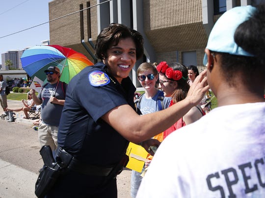 Phoenix Police Chief Jeri Williams greets spectators during the Phoenix Pride Parade in Phoenix April 8, 2018.