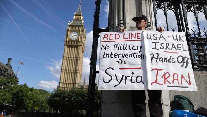 A protester demonstrates outside Parliament on Aug. 29  in London.