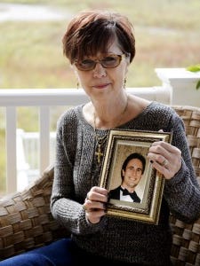 Charlene Sciarretta holds a picture of her son Danny for a portrait outside her home in October 2014. Sciarretta said the photograph is of Danny at his happiest, when he was the best man at a 2003 wedding, one year before he died. Since Danny died of a heroin overdose at age 26 in May 2005, Sciarretta has worked to promote drug abuse awareness. A member of the York County Heroin Task Force, Sciarretta has told her story many times during town hall meetings around the area.   (File photo)