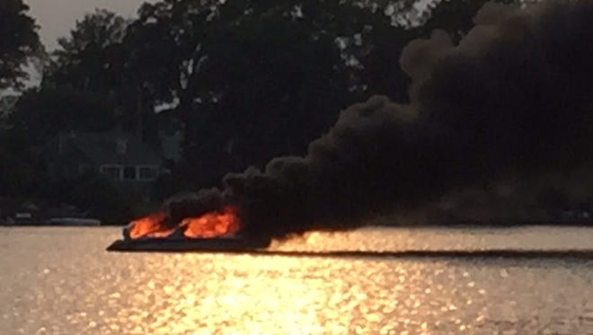 A boat in Lake Mahopac became engulfed in flames after police believe its engine overheated on Friday afternoon.
