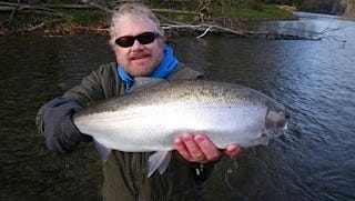The author displays a fine steelhead caught in a tributary of Lake Erie.