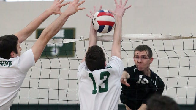 St. Joseph vs. Old Bridge boys volleyball in the GMC Tournament semifinals in Metuchen on Thursday May 19, 2016Old Bridge's # 18 (right) Mike Schon watches as his shot gets between the hands of St. Joseph's # 13 (center) Andrew Esposito.