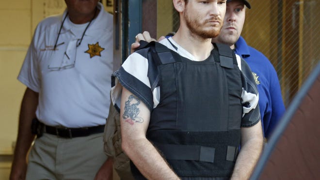 In this Thursday, Sept. 11, 2014 file photo, Smith County Sheriff Charlie Crumpton, left, watches as Timothy Ray Jones Jr., is escorted out of the Smith County Jail. Jury selection is set to begin Monday, April 29, 2019 in the death penalty trial of Jones who police said killed his five young children in their South Carolina home.