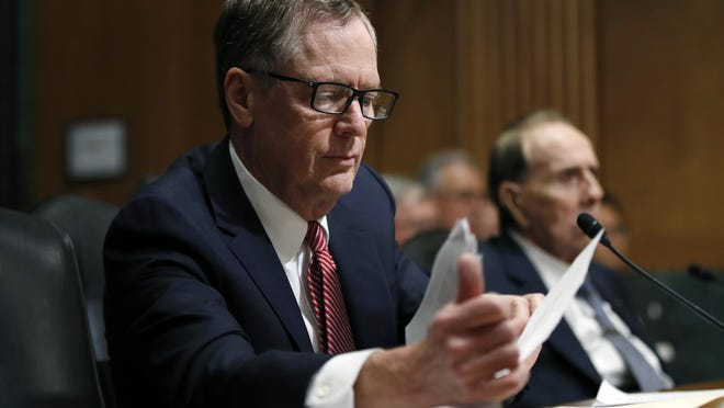 In this March 14, 2017, file photo, United States Trade Representative-nominee Robert Lighthizer, foreground, looks at documents during his confirmation hearing on Capitol Hill in Washington.