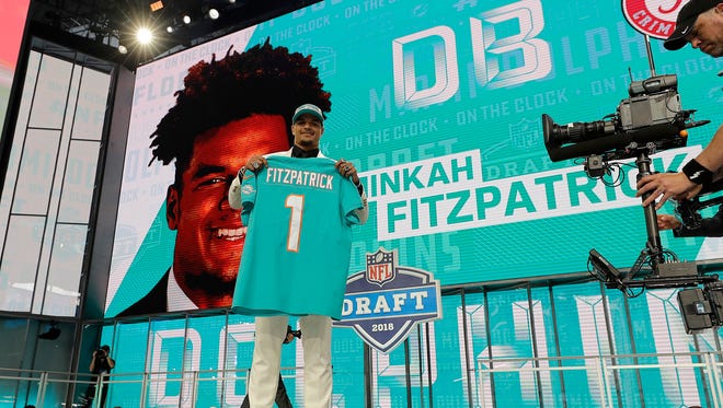 Alabama's Minkah Fitzpatrick holds his Miami Dolphins jersey after being selected by the team during the first round of the NFL football draft, Thursday, April 26, 2018, in Arlington, Texas. (AP Photo/David J. Phillip)