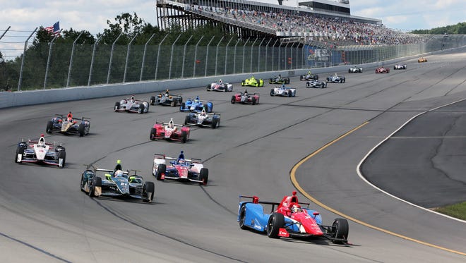Mikhail Aleshin, of Russia, (7) leads the pack at the start of the Pocono IndyCar 500 auto race Monday, Aug. 22, 2016, in Long Pond, Pa. (AP Photo/Mel Evans)