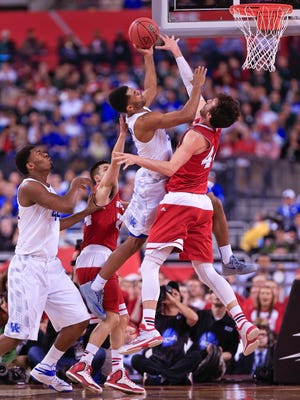 Kentucky's Andrew Harrison scores two against Wisconsin's Frank Kaminsky in the first half Saturday at the Final Four at Lucas Oil Stadium. By Matt Stone, The C-J April 4, 2015.