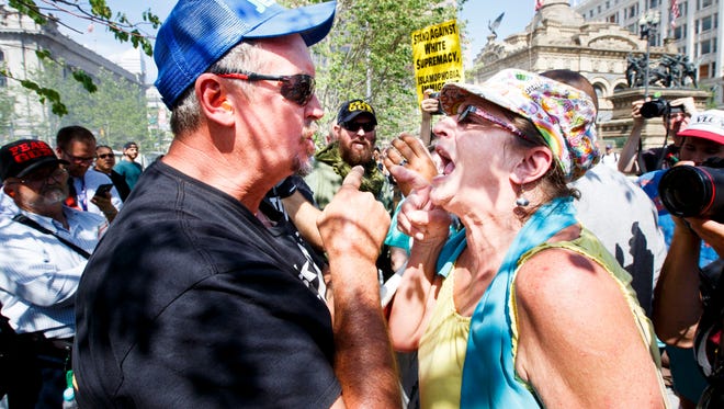 Two people argue about religion and politics in a public square near the Republican National Convention in Cleveland, on July 18, 2016.
