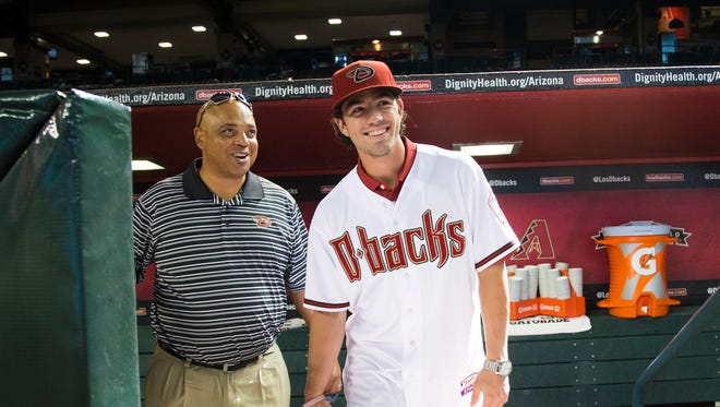 Arizona Diamondbacks first-overall draft pick Dansby Swanson is shown around by De Jon Watson, Diamondbacks Senior Vice President of Baseball Operations, during batting practice before his new team plays against the Miami Marlins at Chase Field July 20, 2015.