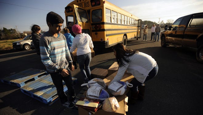 Northampton High School volunteers load their bus with boxed canned goods for delivery in the Eastern Shore News' annual Bank of Cheer on Thursday, Dec. 13, 2012 at the Foodbank in Tasley.