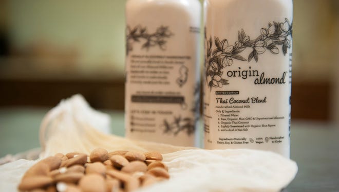 Jacob Deleon, creator of Origin Almond, shows off the almond that go into his product in his Magnolia kitchen.