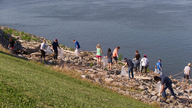 Over fifty volunteers taking part in Ohio River Sweep part of a six-state clean up of the river banks in Evansville, Ind. Saturday morning, June 18, 2016.