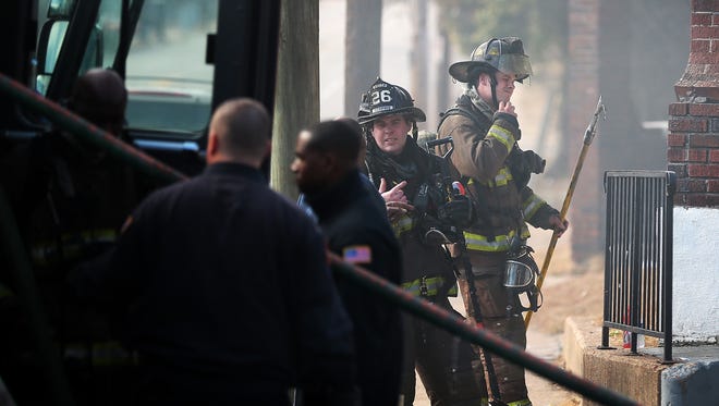 Memphis firefighters battle a short lived house fire at the corner of Dunlap and Chelsea Sunday afternoon. No one was injured in the fire that drew more than a dozen pieces of emergency equipment and left a North Memphis family homeless.