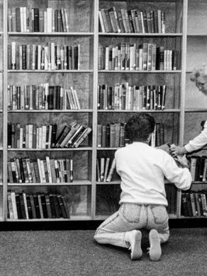 Knox County Schools central office employees Lexa Hooten and Marjorie Rogers stock the shelves at West High School's new library in February 1992.