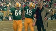 Green Bay Packers quarterback Bart Starr (15) is helped