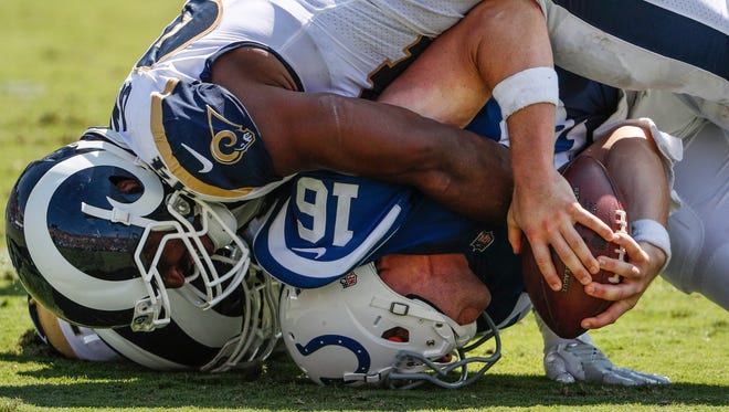 Indianapolis Colts quarterback Scott Tolzien (16) is sacked by Los Angeles Rams linebacker Robert Quinn (94) in the second quarter at Los Angeles Memorial Coliseum in Los Angeles on Sunday, Sept. 10, 2017. 