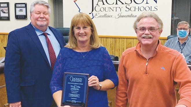 Superintendent Blaine Hess (left) and Board of Education Vice-President Jim Frazier (right) recognized Cathy Pitts (center) who retired as paraprofessional and aide at Ripley Elementary after 18 years of service.