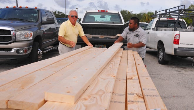 Tibor Menyhart and Kaiton Polkeim load Menyhar’s truck with plywood and 2x6’s at the Home Depot on Merritt Island. Brevard residents started prepping for Irma and stores got busy with shoppers looking for plywood, gas and water. 