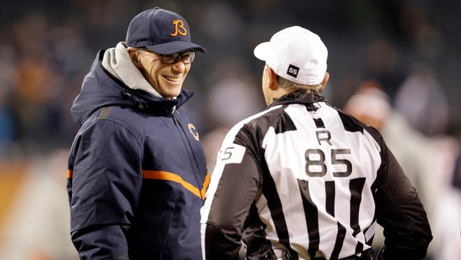 Chicago Bears coach Marc Trestman talks to referee Ed Hochuli (85) before a game between the Chicago Bears and the Dallas Cowboys on Thursday, Dec. 4, 2014, in Chicago.