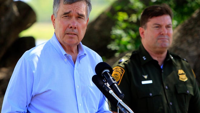 U.S. Customs and Border Protection Commissioner Gil Kerlikowske (left) talks about the dangers of crossing the U.S. border during a news conference for a Danger Awareness Campaign at Anzalduas Park next to the Rio Grande River in Mission, Texas on July 2, 2014.