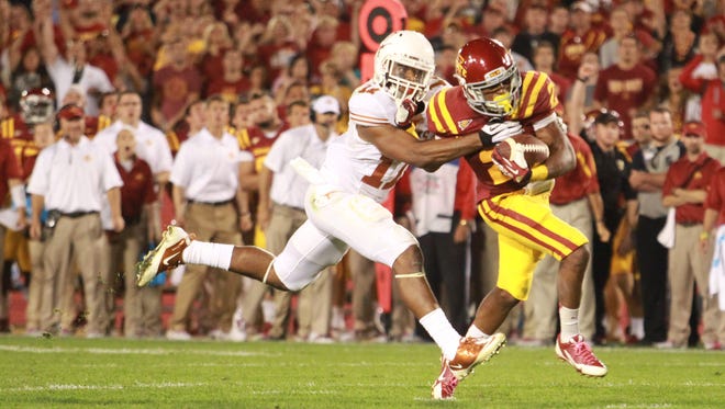 Texas linebacker Tevin Jackson (11) struggles to slow Iowa State running back Aaron Wimberly (2) during the fourth quarter Thursday at Jack Trice Stadium.