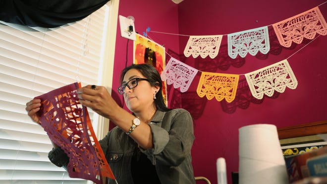 Artist Yreina Flores, 36, creates unique papel picado artwork in her studio on Friday, March 4, 2016 in Indio, Calif.