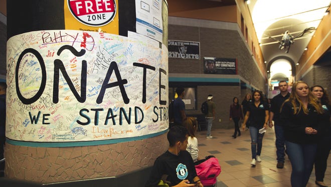Oñate High School students made a poster, left, reading “Oñate Knights We Stand Strong” to show support for the football team.