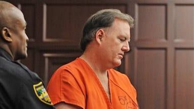 Defendant Michael Dunn is directed to his seat in the courtroom for a hearing Sept. 11 in Jacksonville, Fla. Judge Russell Healey said he will wait until jury selection begins to determine whether to move Dunn's first-degree murder trial in the killing of a teenager during an argument over loud music. The 47-year-old Dunn was convicted of three counts of attempted second-degree murder and firing into an occupied vehicle,  but the jury deadlocked on the first-degree murder charge for killing 17-year-old Jordan Davis.