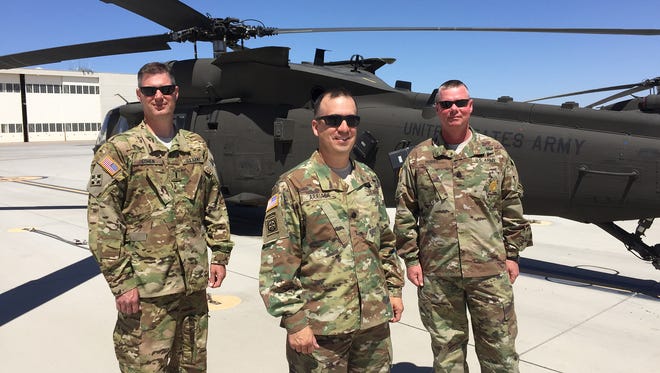 From left, Chief Warrant Officer 4 Justin Cohen, Lt. Col. Jason Arriaga and Command Sgt. Maj. Troy S. Hubbs are the command team for 3rd Battalion, 501st Aviation Regiment. Their unit will be deploying and leading an aviation task force to Europe this summer.