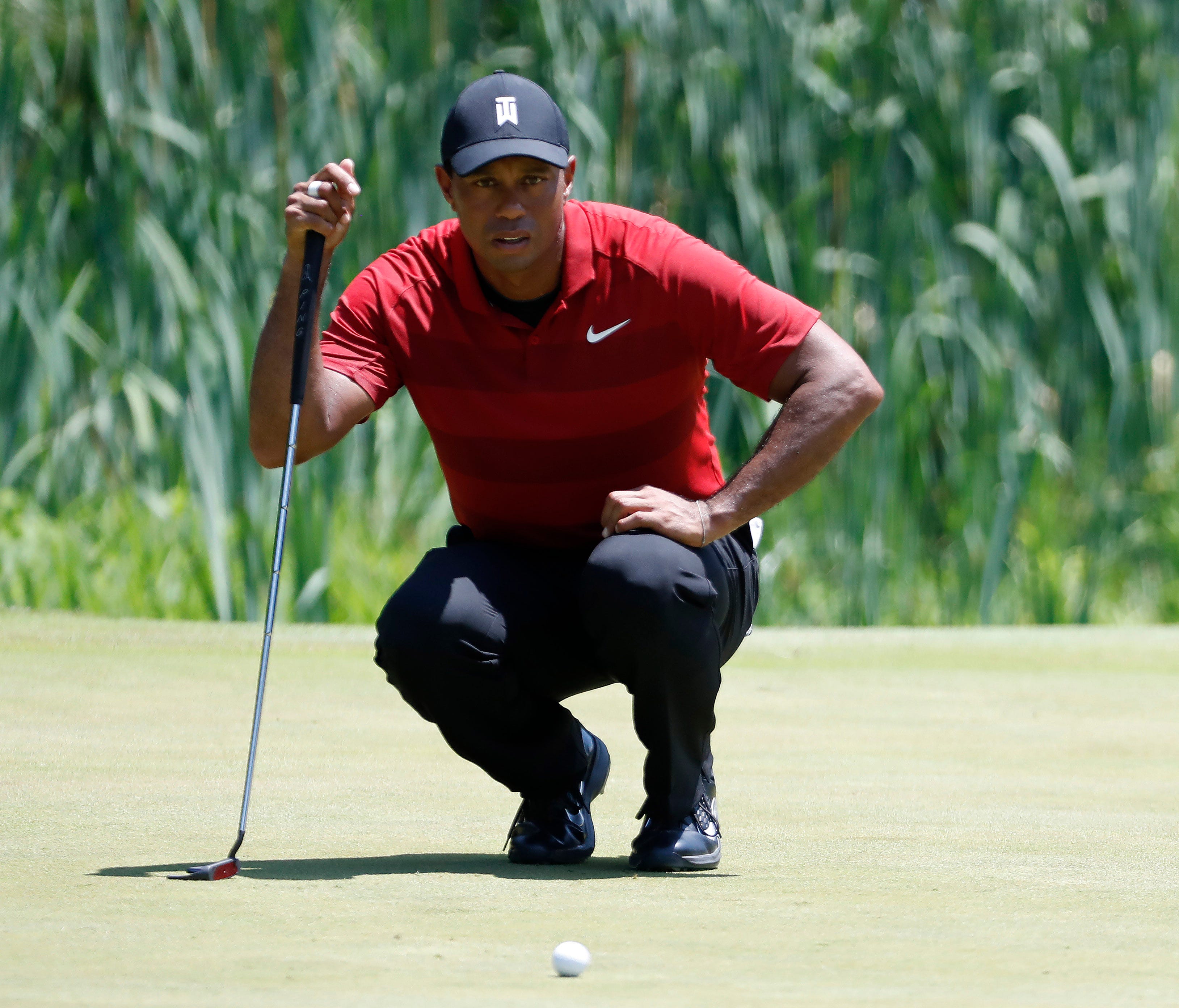 Tiger Woods lines up a birdie putt on the third hole during the final round of The National golf tournament at TPC Potomac at Avenel Farm on July 1.