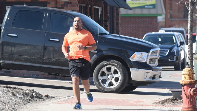 Wearing shorts and a short-sleeved, James Allison of Southfield jogs along Michigan Avenue in Detroit on a warm and sunny afternoon, Tuesday February 27, 2018.