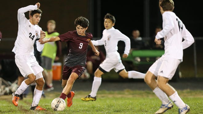 Cooper's Max Zorn tries to control the ball in heavy Ryle traffic during their 33rd District Final at Cooper, Thursday, October 13, 2016.