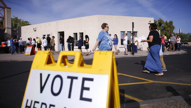 People wait in line to vote in the Arizona presidential primary election at Mountain View Lutheran Church on March 22, 2016,  in Phoenix.
