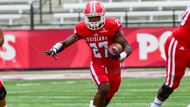 Running back Jordan Wright finds a hole for a big run at UL's annual spring game last April.