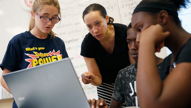 In this June 29, 2016, photo, Crystal Nunes, second from left, works with students at Rebel Academy in North Las Vegas. Rebel Academy, spearheaded by UNLV's College of Education, is a project to give prospective teachers hands-on experience during the summer.