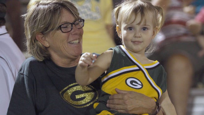 The youngest Gallatin cheerleader watches the game.