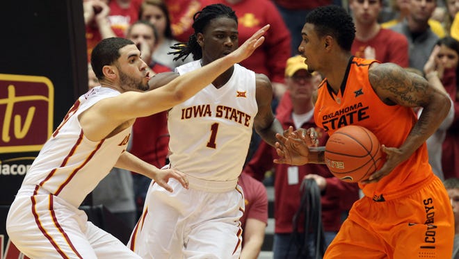 Oklahoma State Cowboys guard/forward Le'Bryan Nash (2) is defended by Iowa State Cyclones forward Jameel McKay (1) and Iowa State Cyclones forward Georges Niang (31) at James H. Hilton Coliseum. The Cyclones beat the Cowboys 63 to 61.